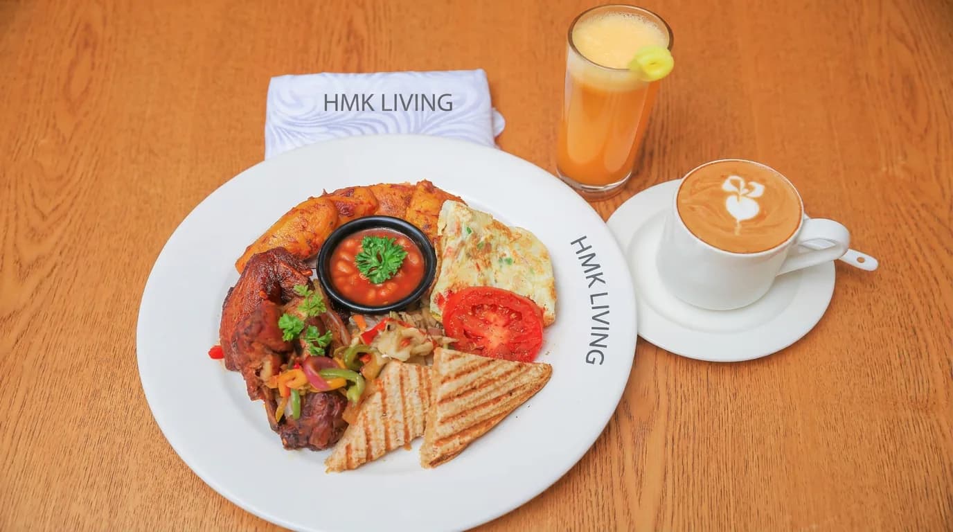 Full breakfast plate with juice and coffee at HMK Living, Kigo Kampala