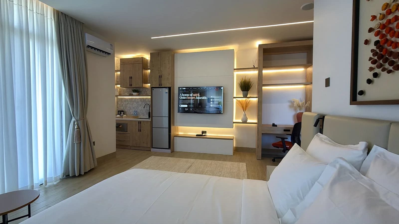 Studio with its own kitchenette and media wall at HMK Living, Kigo Kampala