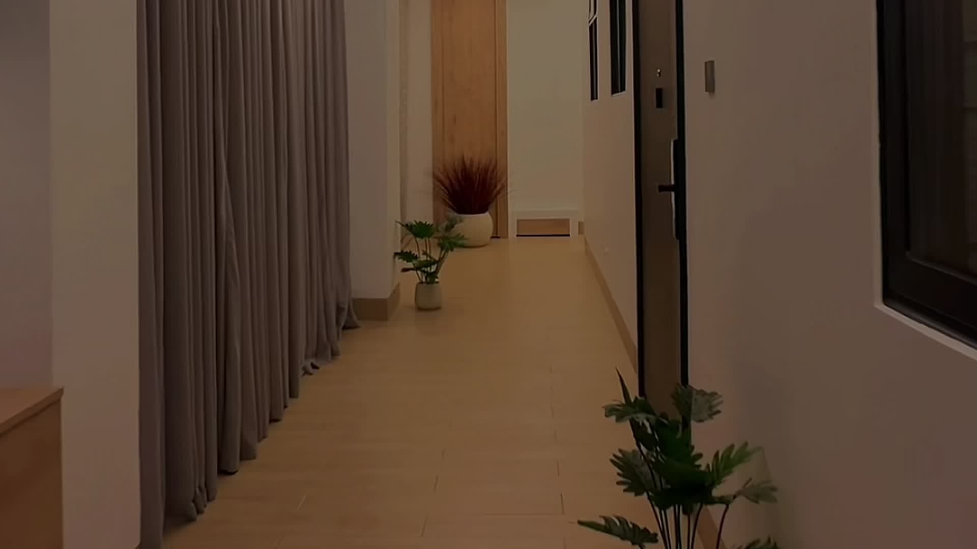 The lit corridor to the apartments at HMK Living, Kigo Kampala
