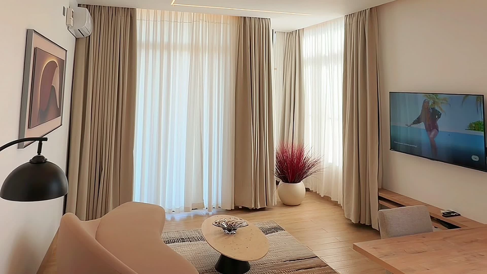 A quiet lounge behind drawn curtains at HMK Living, Kigo Kampala